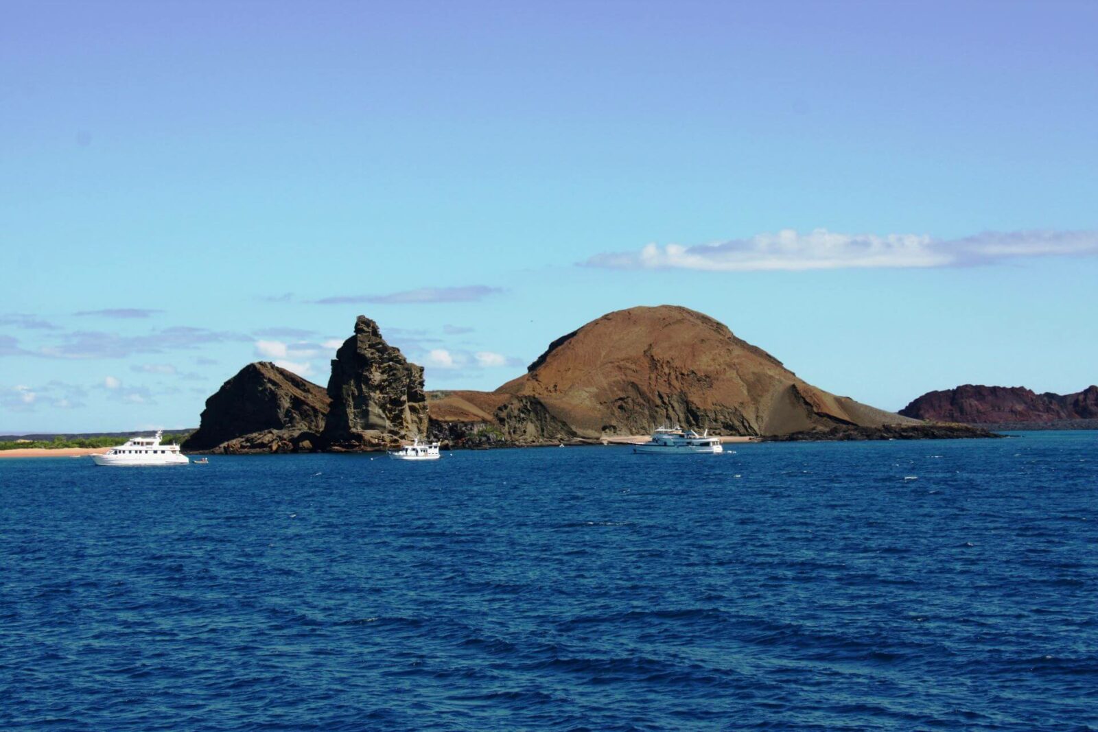Brown rock formations in the Pacific Ocean surrounding the Galápagos Islands