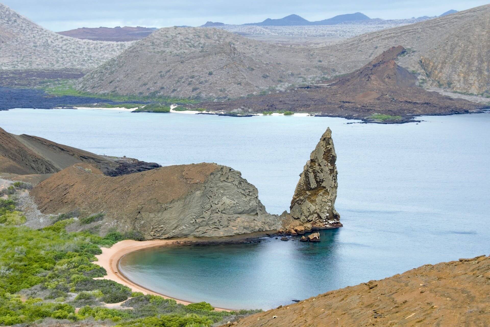 Mountains and rock formations line the coast of the Galápagos Islands